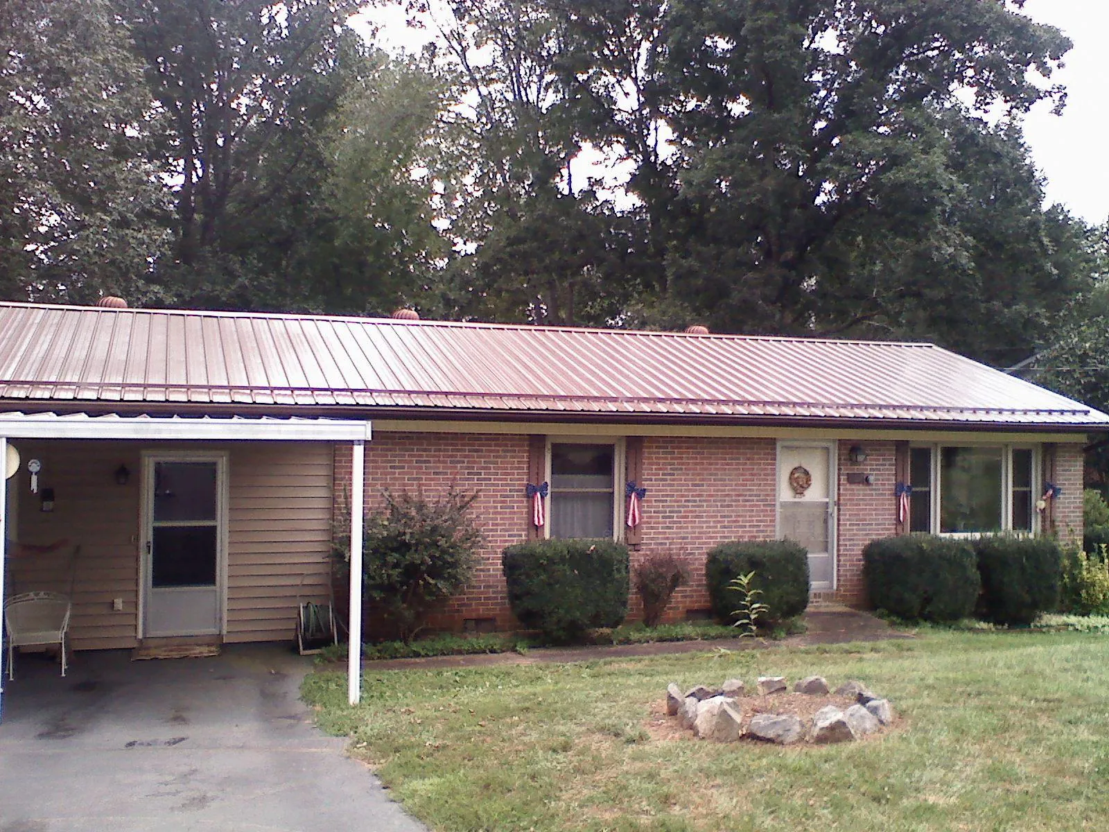 Bronze metal roof and carport on a brick ranch home — Roof Repair work by our crew in New Cambria